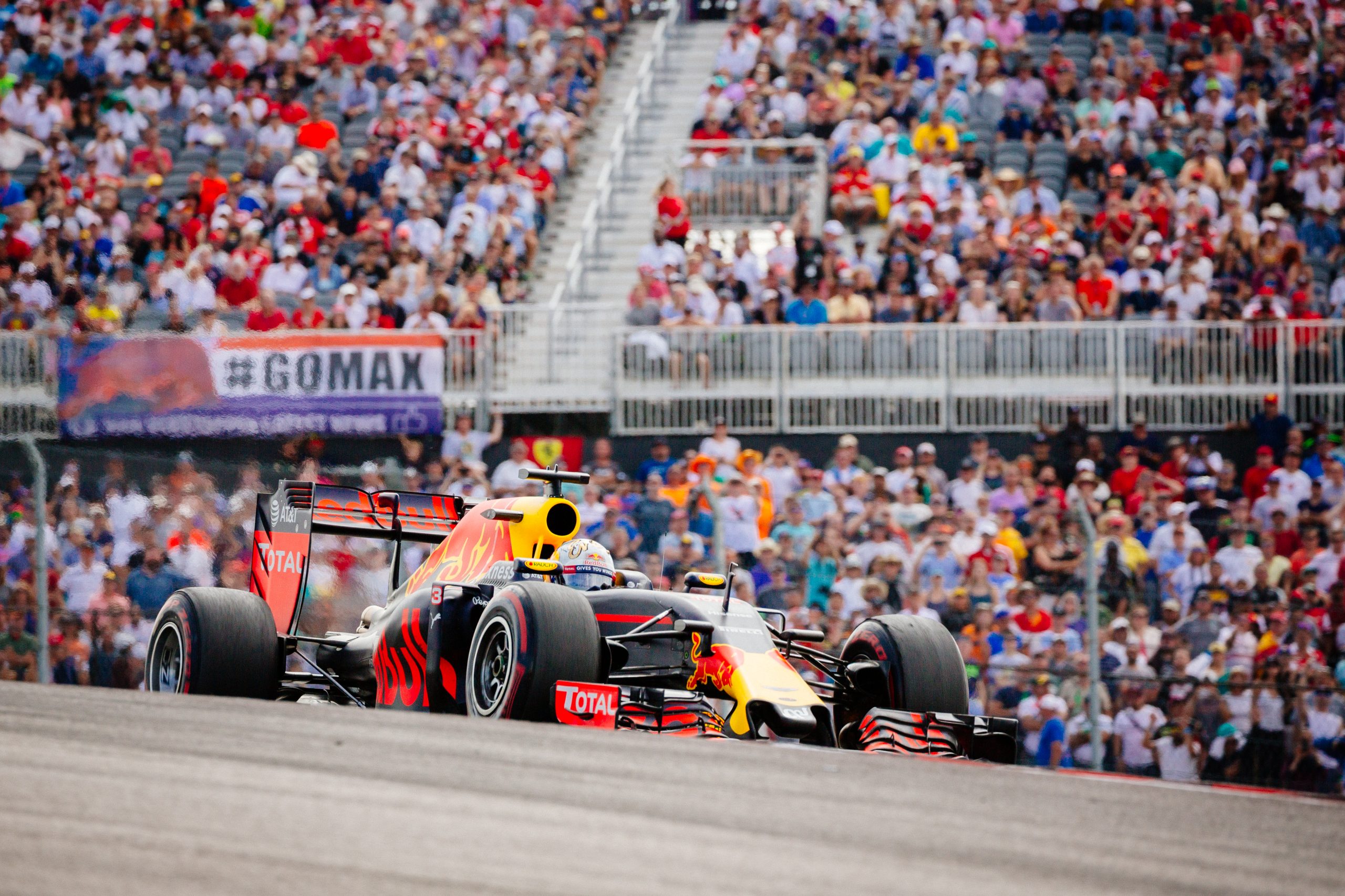 Daniel Ricciardo crests the hill of exiting Turn 1 at Circuit of the Americas during the 2016 F1 United States Grand Prix.