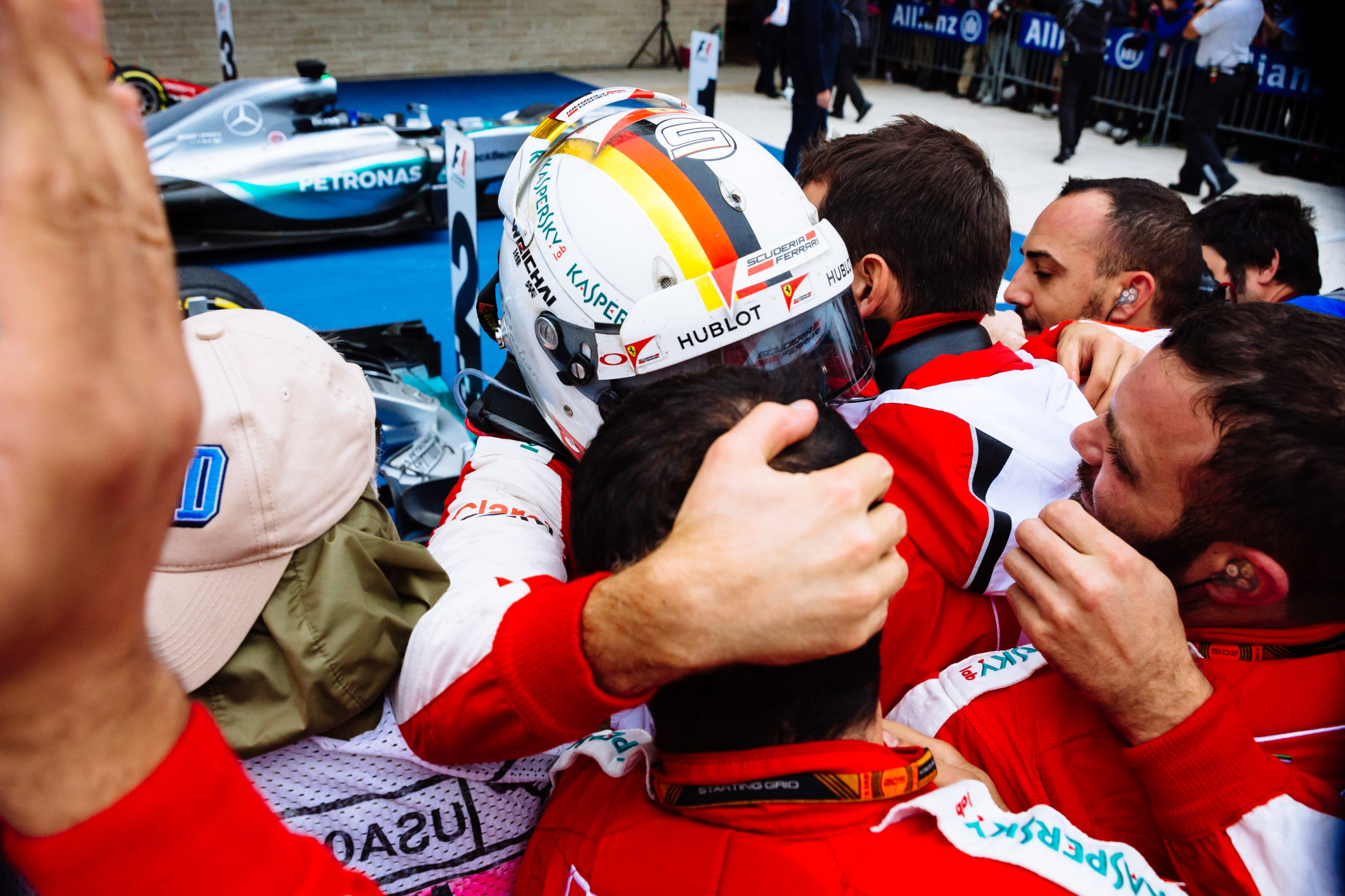 Sebastian Vettel celebrates his 3rd place finish during the 2015 United States Grand Prix with his team.