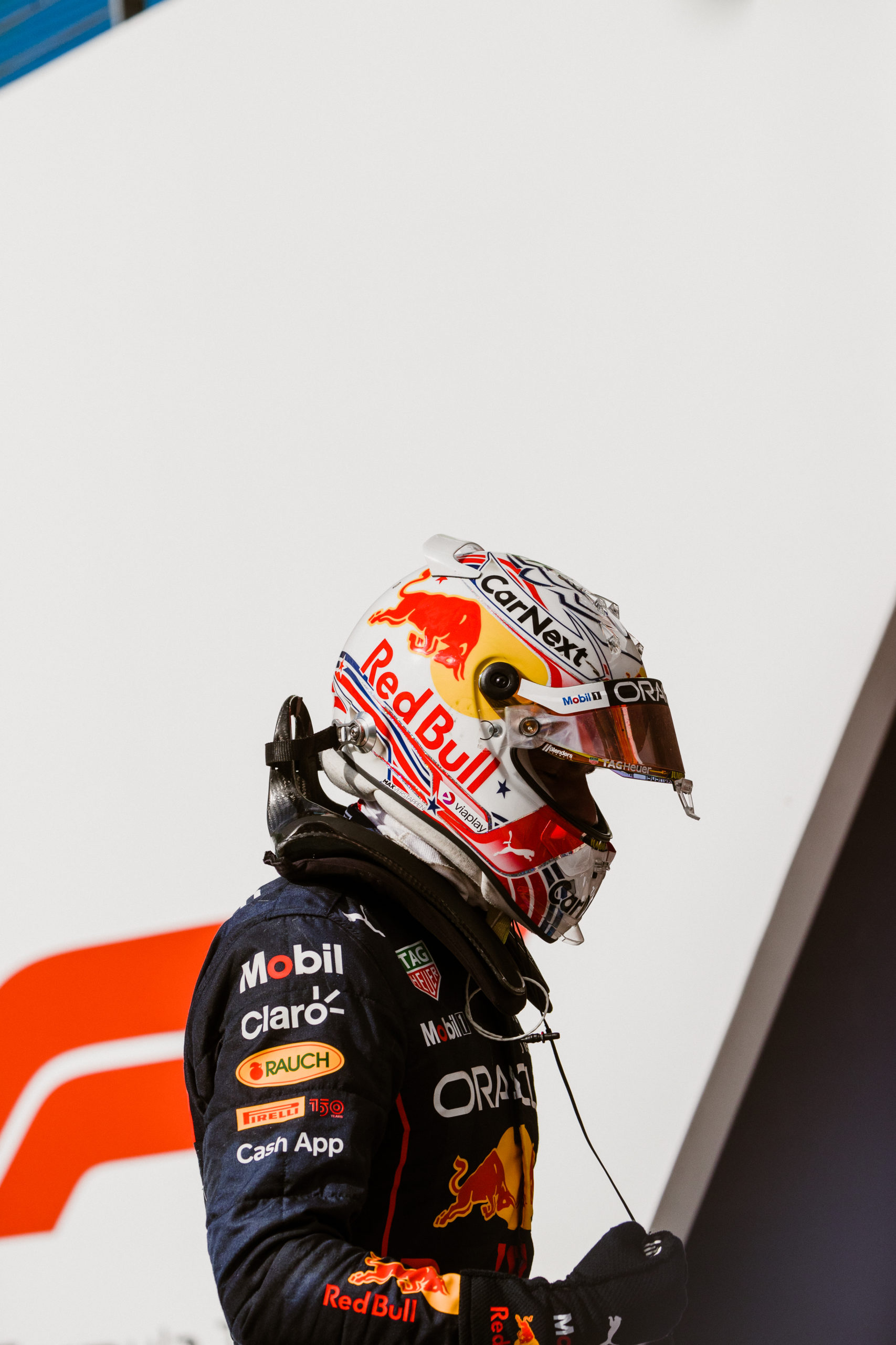 Oracle Red Bull Racing's Max Verstappen stands atop his car as he celebrates taking victory at the 2022 Formula 1 Aramco United States Grand Prix at Circuit of the Americas.
